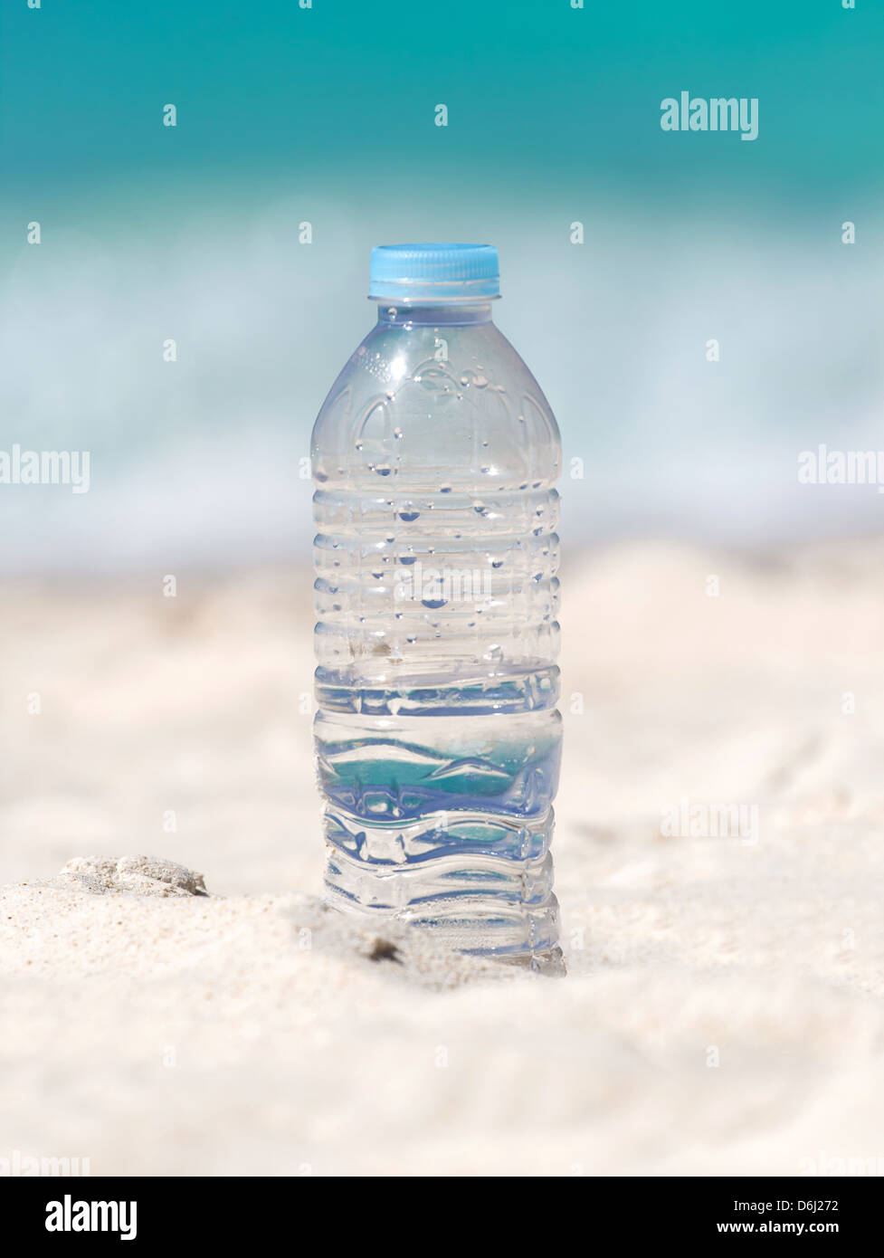 Drinking water in bottle on sand on tropical beach Stock Photo Alamy