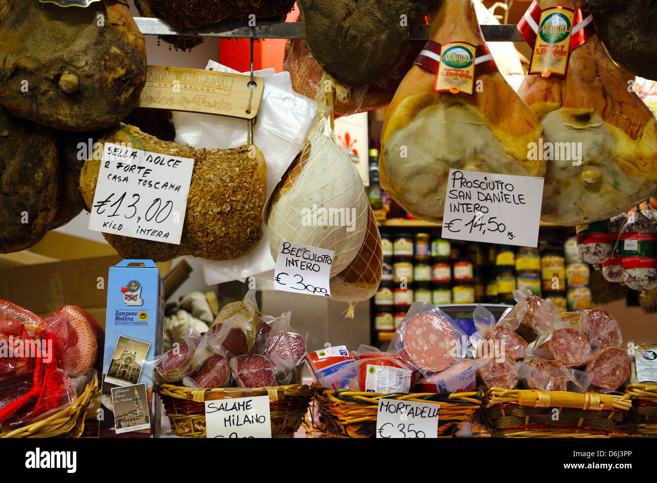 A selection of hams and salami on display in San Lorenzo market in Florence Italy Stock Photo