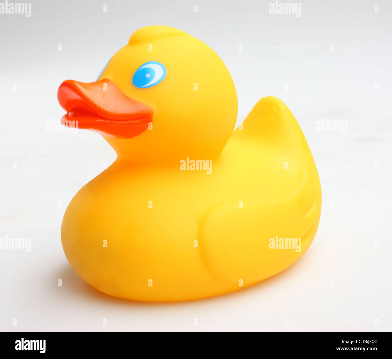Yellow rubber Duck with blue eyes and orange beak on white background side view Stock Photo
