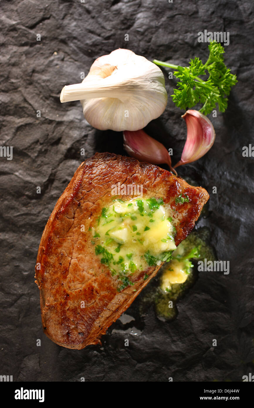 Fillet of steak with melted garlic butter (and garlic bulb and garlic