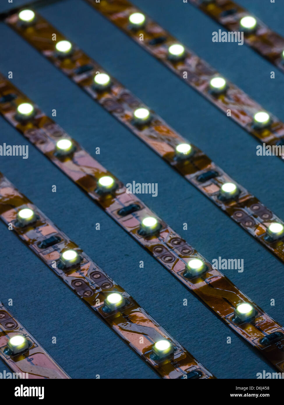Close up of high intesity LED lighting strips illuminated with very narrow depth of field. Printed circuitry clearly seen. Stock Photo
