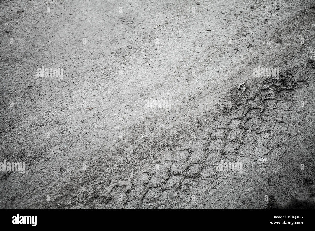 Abstract traffic background. Close-up view of tires tracks on the road dirt Stock Photo