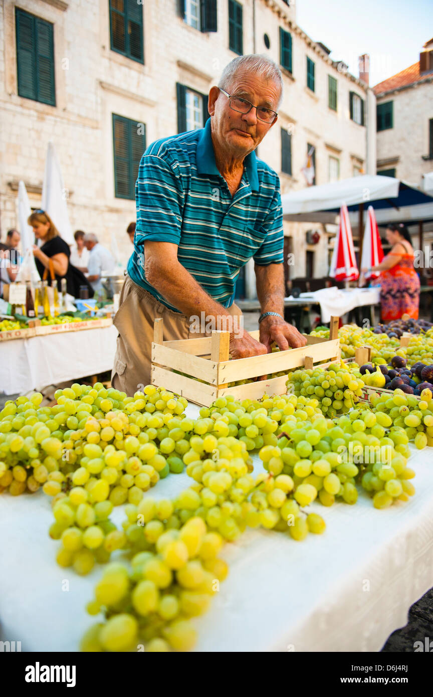 Vendor at Dubrovnik Market setting up his stall for Gundulic fruit market in Gundulic Square, Dubrovnik, Croatia, Europe Stock Photo