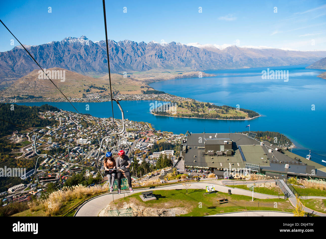 Two tourists on the gondola to the luge track above Queenstown, Otago, South Island, New Zealand, Pacific Stock Photo