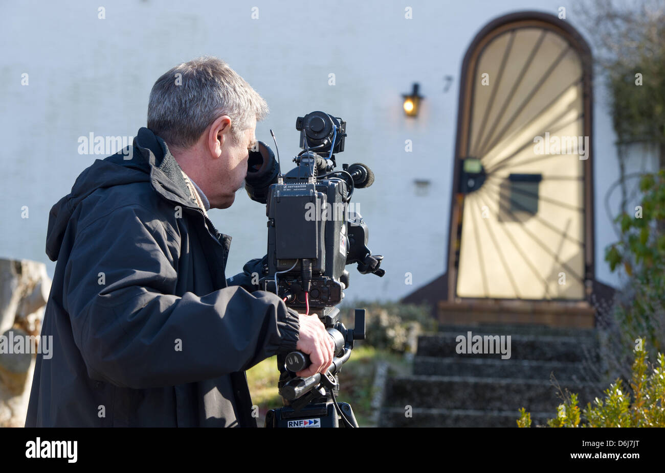 Journalists film the entrance to the house of a 78 year old man in Weilerbach, Germany, 06 March 2012. He shot and killed two doctors and injured a doctor's assitant yesterday. While fleeing, he shot at a police officer and took his own life. Photo: UWE ANSPACH Stock Photo