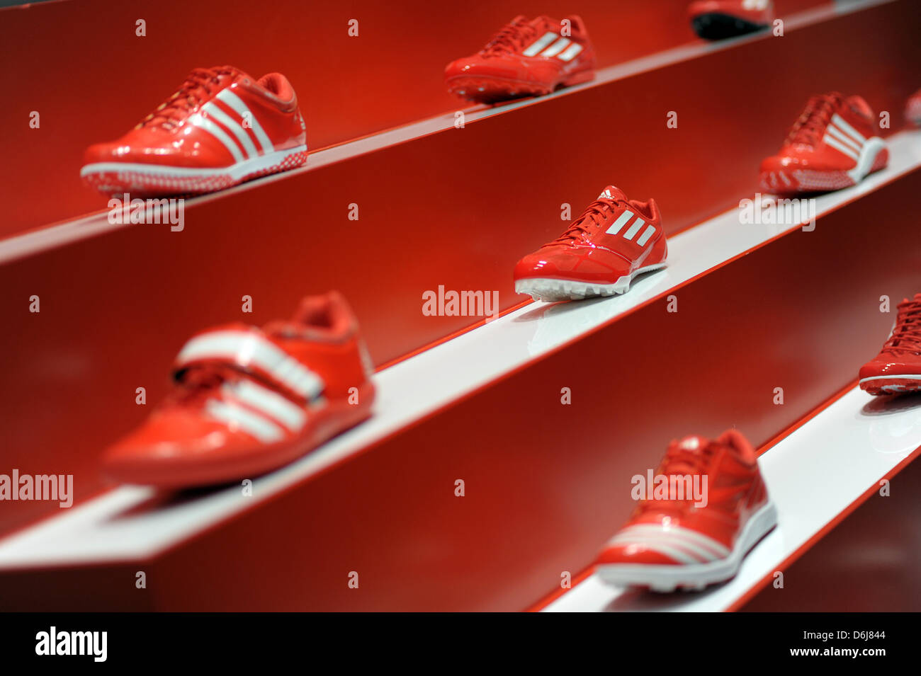 Red adidas soccer shoes are on display during a press conference on the  company's annual results in Herzogenaurach, Germany, 07 March 2012. The  sports goods business is booming, and adidas is reaping