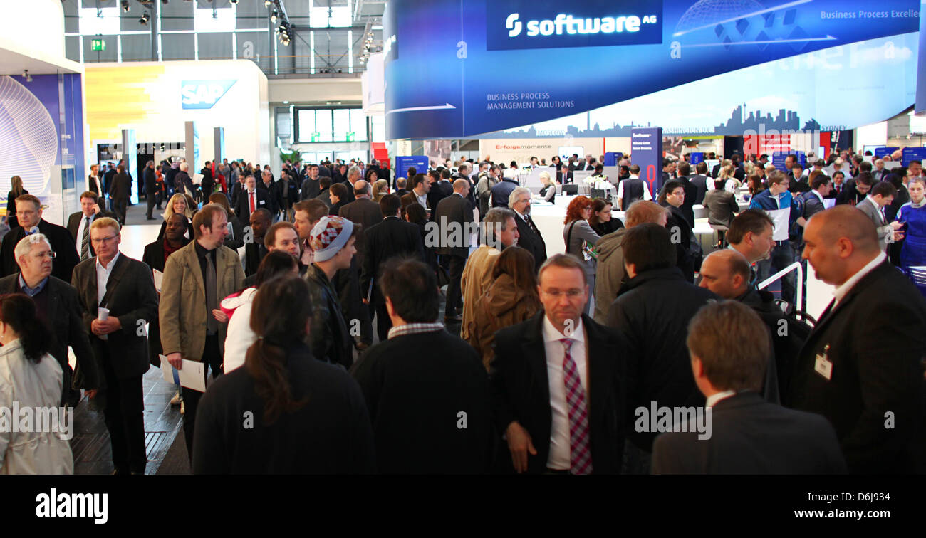 Visitors walk past the exhibition booth of the company Software AG at the CeBIT in Hanover, Germany, 07 March 2012. More than 4200 companies from 70 countries will present their products at the world's biggest computer trade show CeBIT 2012 in Hanover. Photo: Daniel Reinhardt Stock Photo