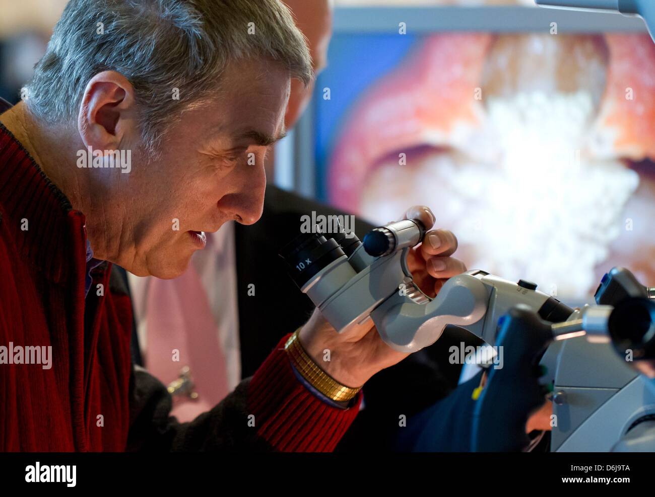 Hans-Juergen Kirchner observes the microscope Pentero 900 during the shareholders meeting of the multinational medical technology company Carl Zeiss Meditec AG in Weimar, Germany, 09 March 2012. The TecDAX enterprise achieved an increase in turnover of 12.1 percent leading to 759 million euros and managed to achieve earnings before interest and taxes of 103.6 million euros. Photo:  Stock Photo