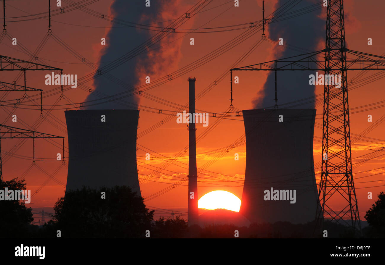 (dpa-file) - The sun sets behind the cooling towers of the nuclear power plant in Grafenrheinfeld, Germany, 21 August 2011. One year after the catastrophy of Fukushima, one hears only little of the German Atomforum, a forum of lobbyists promoting nuclear economy. Photo: Daniel Karmann Stock Photo