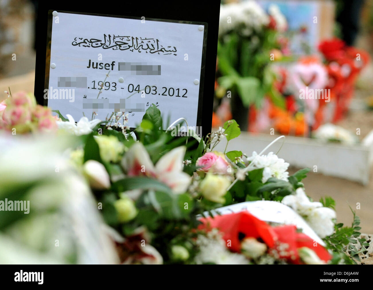 NEW (Corrected nationality of the victim) Flowers lay on the grave of a young German-Lebanese man at Sehitlik Mosque in the Neukoelln area of Berlin, Germany, 09 March 2012. The 18 year old was stabbed by a 34 year old in self defence in southern Neukoelln. The public prosecutor is not issuing an arrest warant for the time being. The father of the boy spoke against any kind of retr Stock Photo