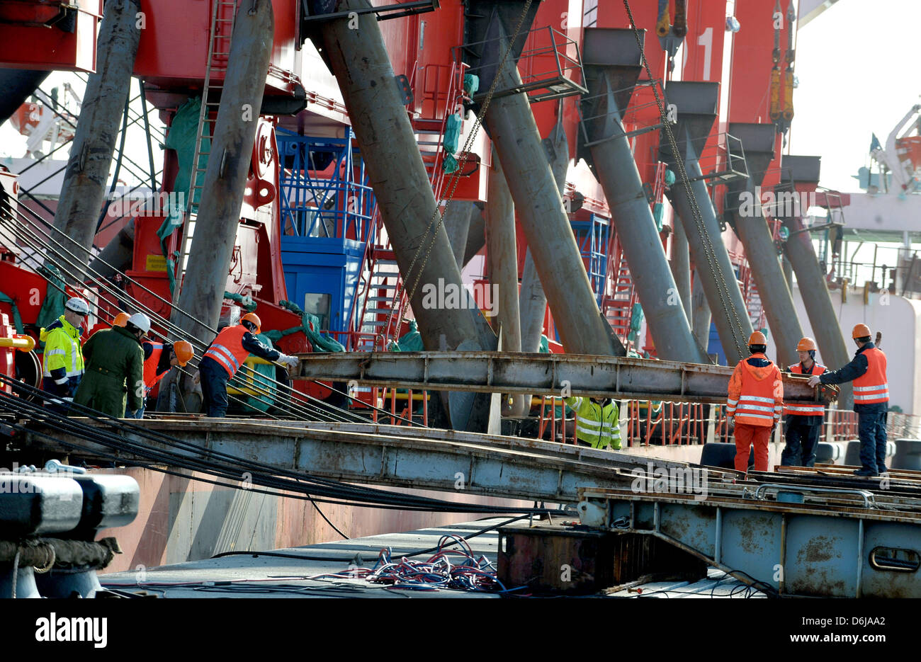Chinese workers prepare the first of four new container gantries to be ...