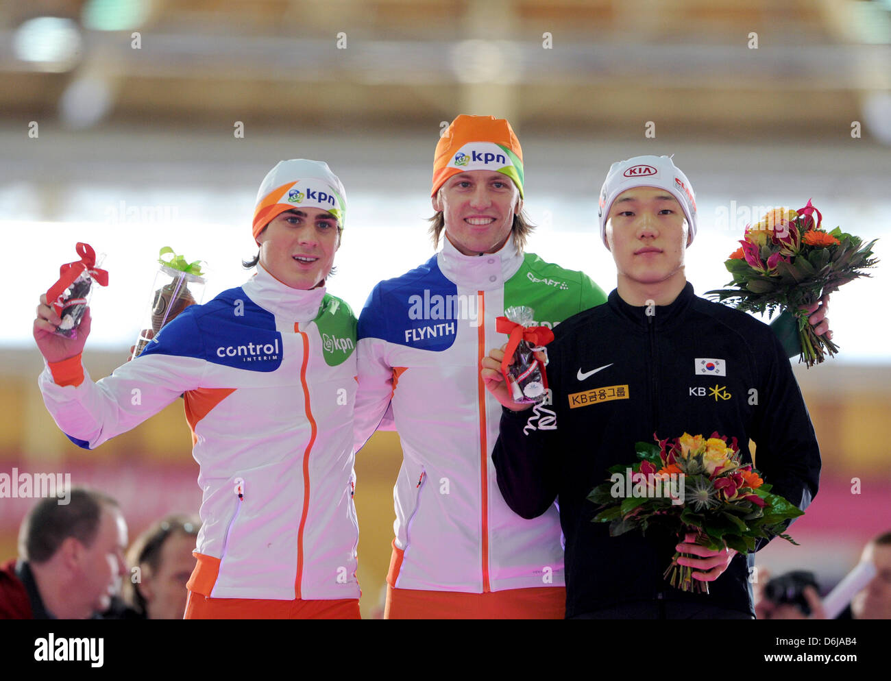 First place in the 500 m distance Michel Mulder from the Netherlands, second place Tae-Bum Mo from Korea (R) and third place Jan Smeekens from the Netherlands (L) stand  during the medal ceremony at the Speed Skating World Cup in Berlin, Germany, 10 March 2012. Photo: SOEREN STACHE Stock Photo