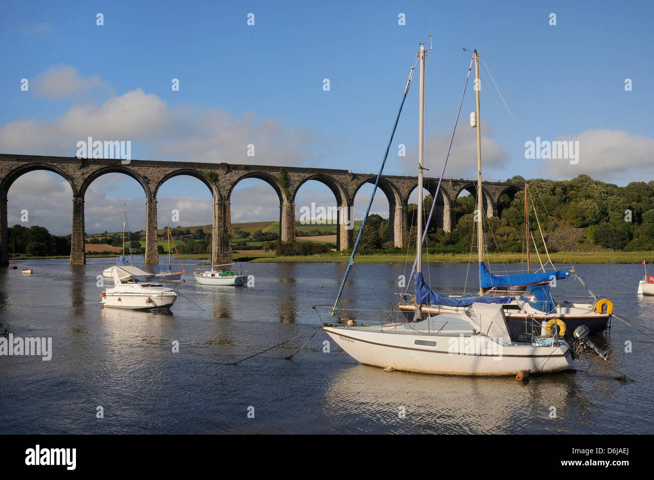 Sailing yachts moored in the River Lynher at high tide below St. Germans railway viaduct, Cornwall, England, UK Stock Photo