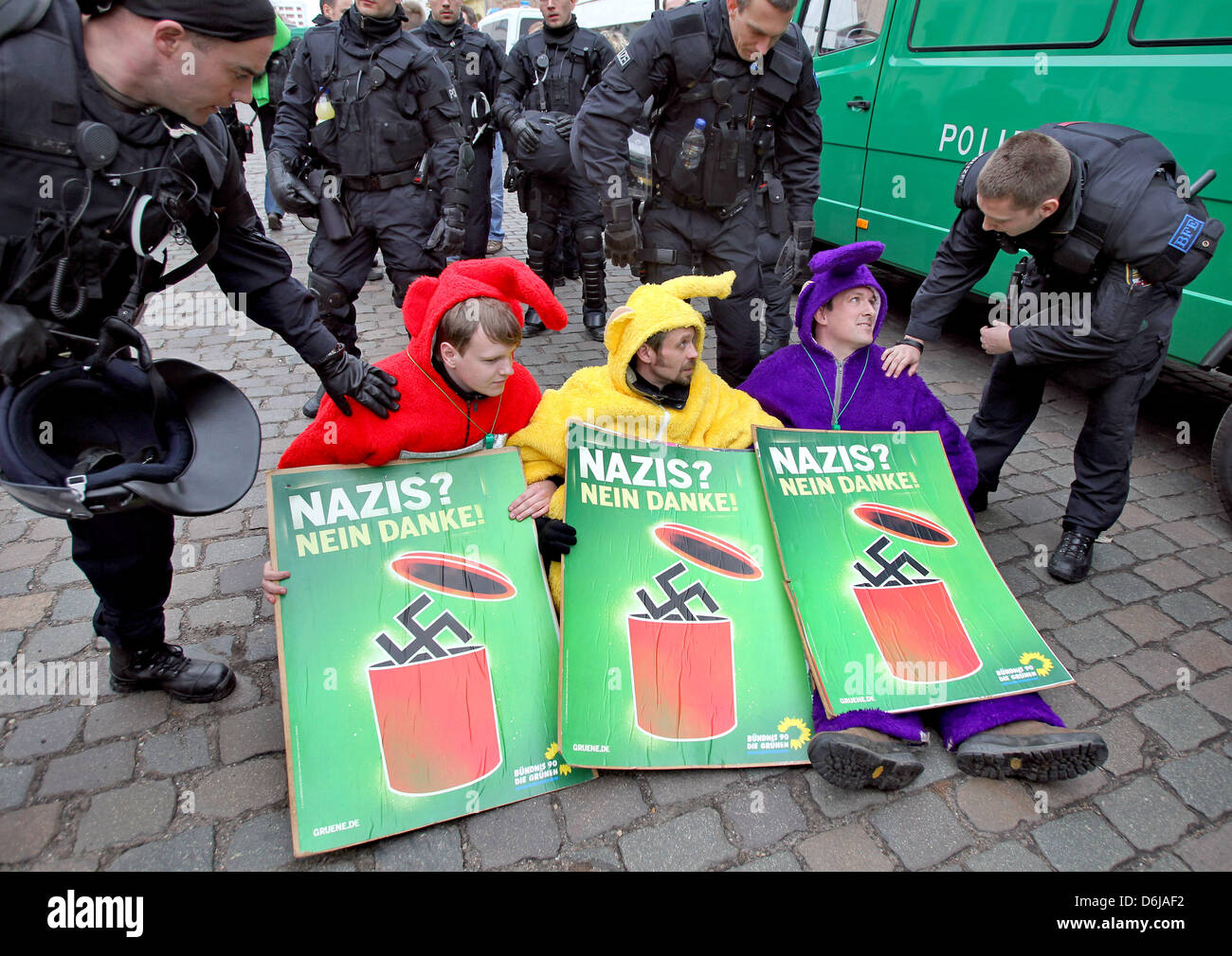 Counter-demonstrators dressed as Teletubbies protest against a far-right extremist rally in Dessau-Rosslau, Germany, 10 March 2012. People are protesting against a rally of around 150 far-right extremists on the occassion of the aerial bombing of the city by Allied forces in March 1945. The historical event in Dessau has been used for right-wing propaganda for years. Photo: JAN WOI Stock Photo