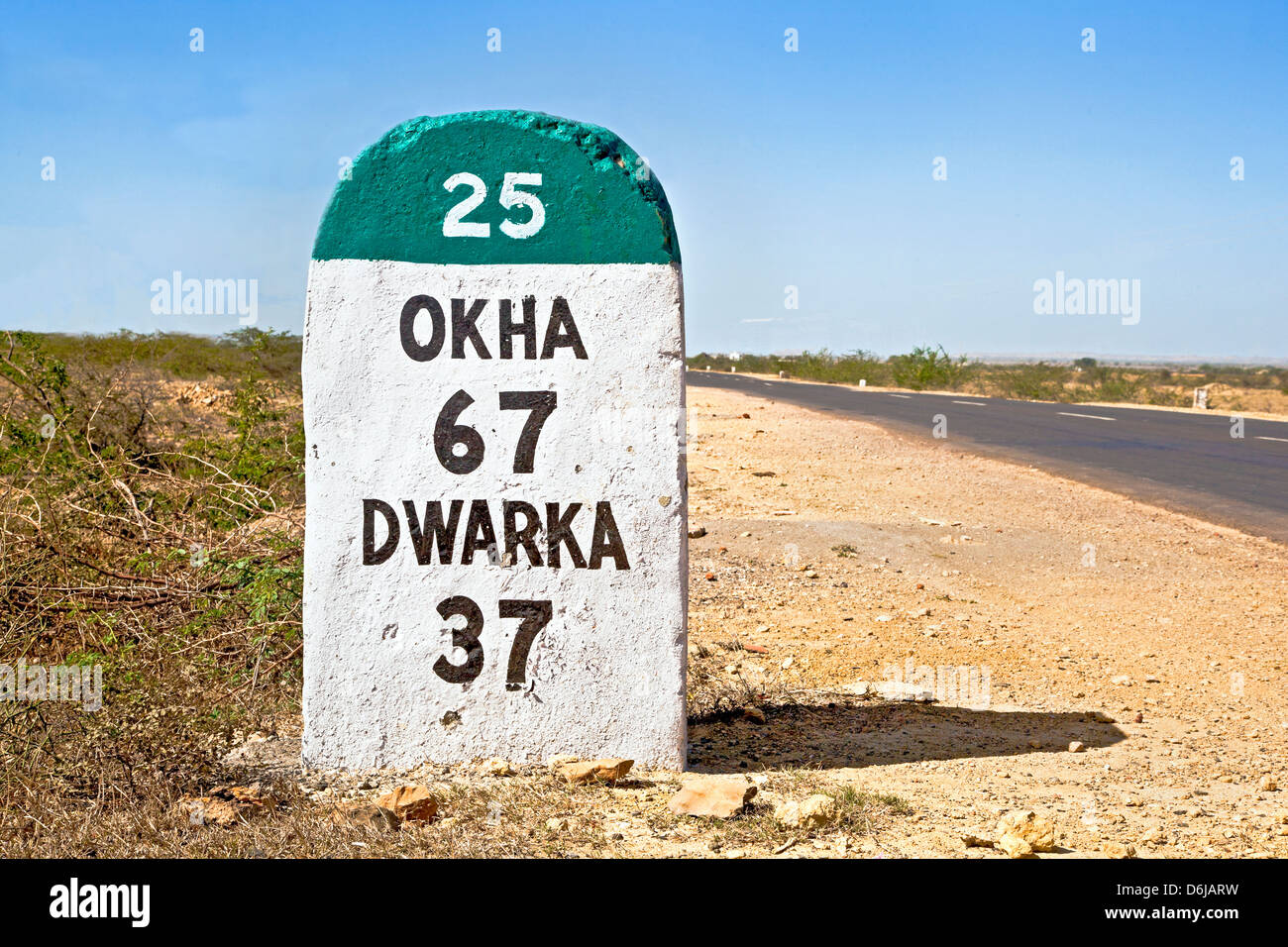 Gujarat India, the 37 kilometers Milestone to Dwarka on the state highway 25 which runs through a barren part of the country Stock Photo