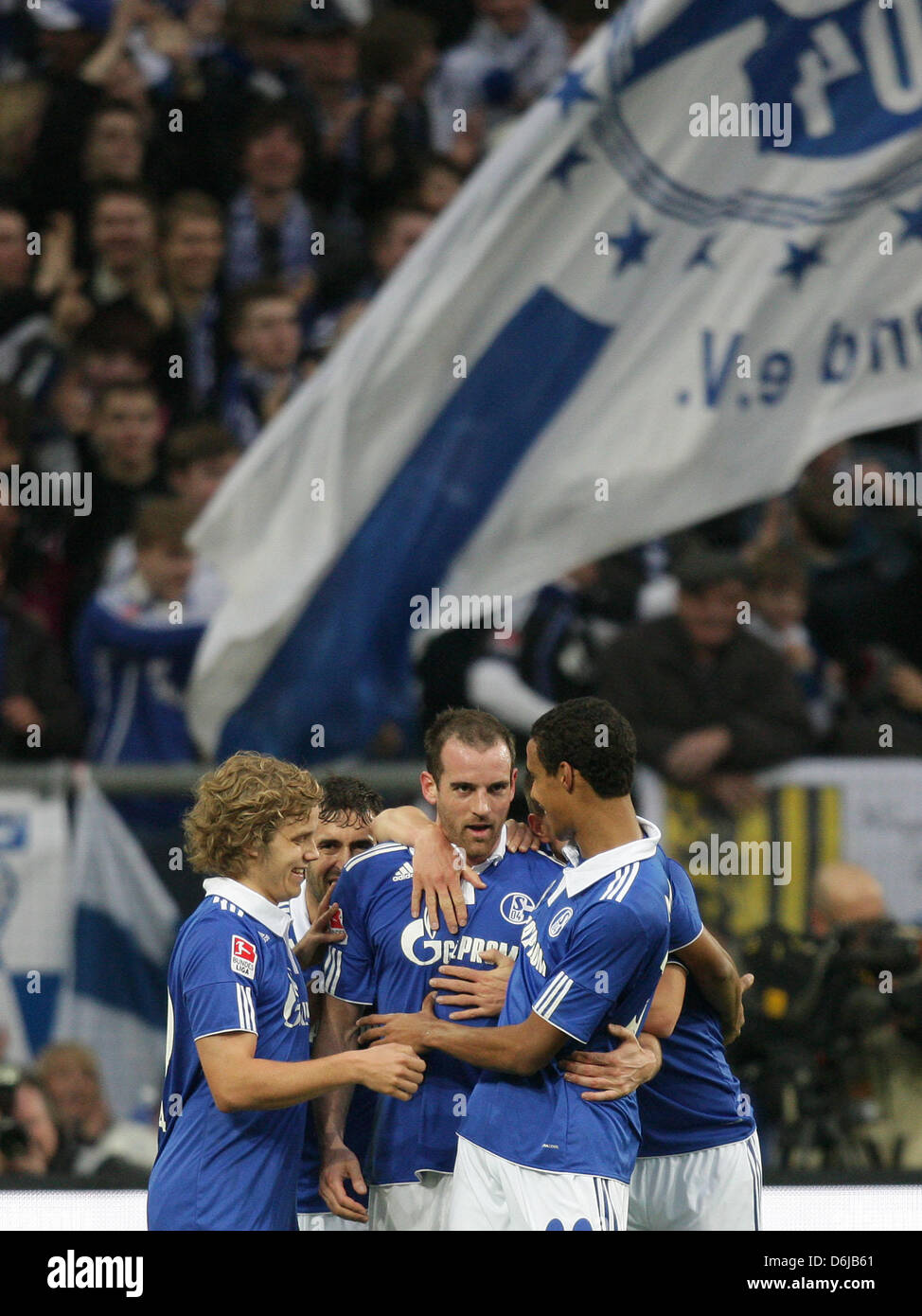 Schalke's Christoph Metzelder (C) celebrates his 2-0 goal with team-mates Teemu Pukki (L) and Joel Matip during the Bundesliga soccer match between FC Schalke 04 and Hamburger SV at Veltins Arena in Gelsenkirchen, Germany, 11 March 2012. Photo: Rolf Vennenbernd  (ATTENTION: EMBARGO CONDITIONS! The DFL permits the further utilisation of the pictures in IPTV, mobile services and othe Stock Photo