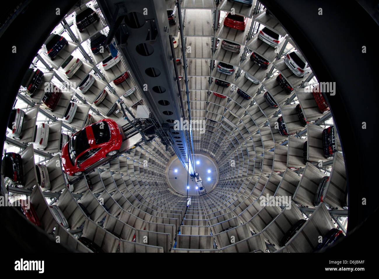 A Volkswagen up! and a red Beetle float to vacant lots inside the sales