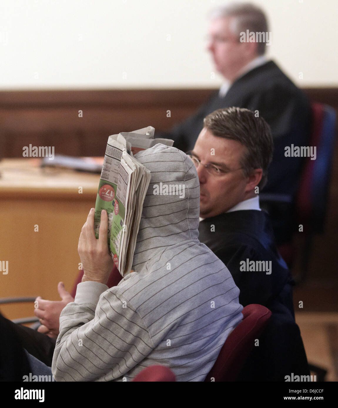 The accused Hussam S. (L) sits next to his lawyer Christoph Clanget (C) in a court room of the Higher Regional Court in Koblenz, Germany, 04 March 2012. The federal prosecutor's office accuses Hussam S. of supporting terrorist organisations between Septembr 2007 and December 2009. He is supposed to have aided the distribution of propaganda material of al-Quaeda and the Islamic Jiha Stock Photo