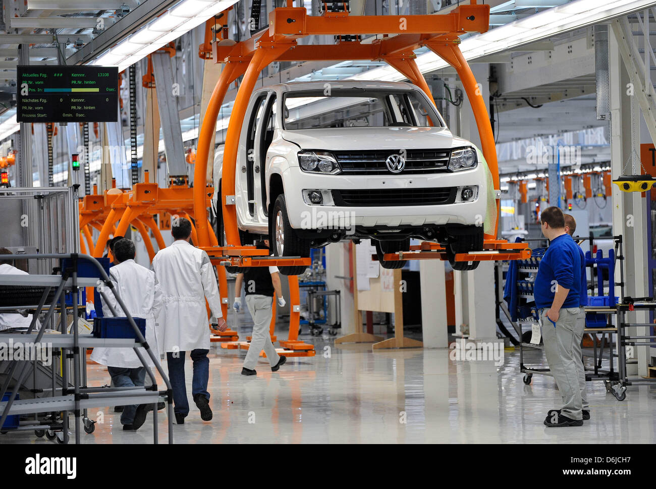 Employees of car manufacturer VW assemble a VW Amarok at the Volkswagen