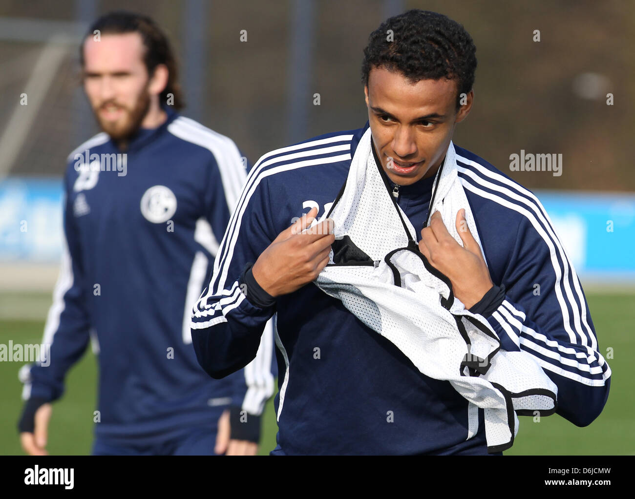 Schalke's Joel Matip (R) puts on a vest during practice on the practice field at Arena AufSchalke in Gelsenkirchen, Germany, 14 March 2012. FC Schalke with play Twente Enschede in the Europa League on Thursday, 15 March 2012. Photo: FRISO GENTSCH Stock Photo