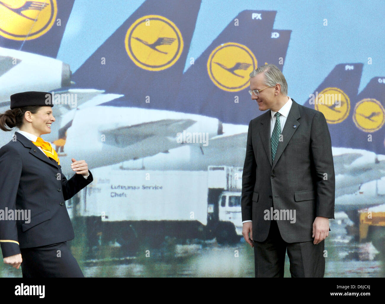 Lufthansa AG CEO, Christoph Franz (R), and a stewardess stand in front of a photo wall showing Lufthansa aircrafts during the Lufthansa financial statement press conference in Frankfurt/Main, Germany, 15 March 2012. Photo: BORIS ROESSLER Stock Photo