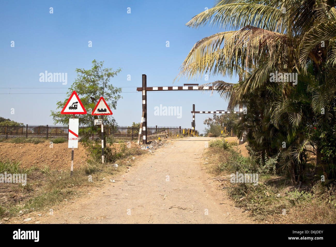 landscape of an open barrier railway level crossing in the countryside of India Stock Photo Alamy