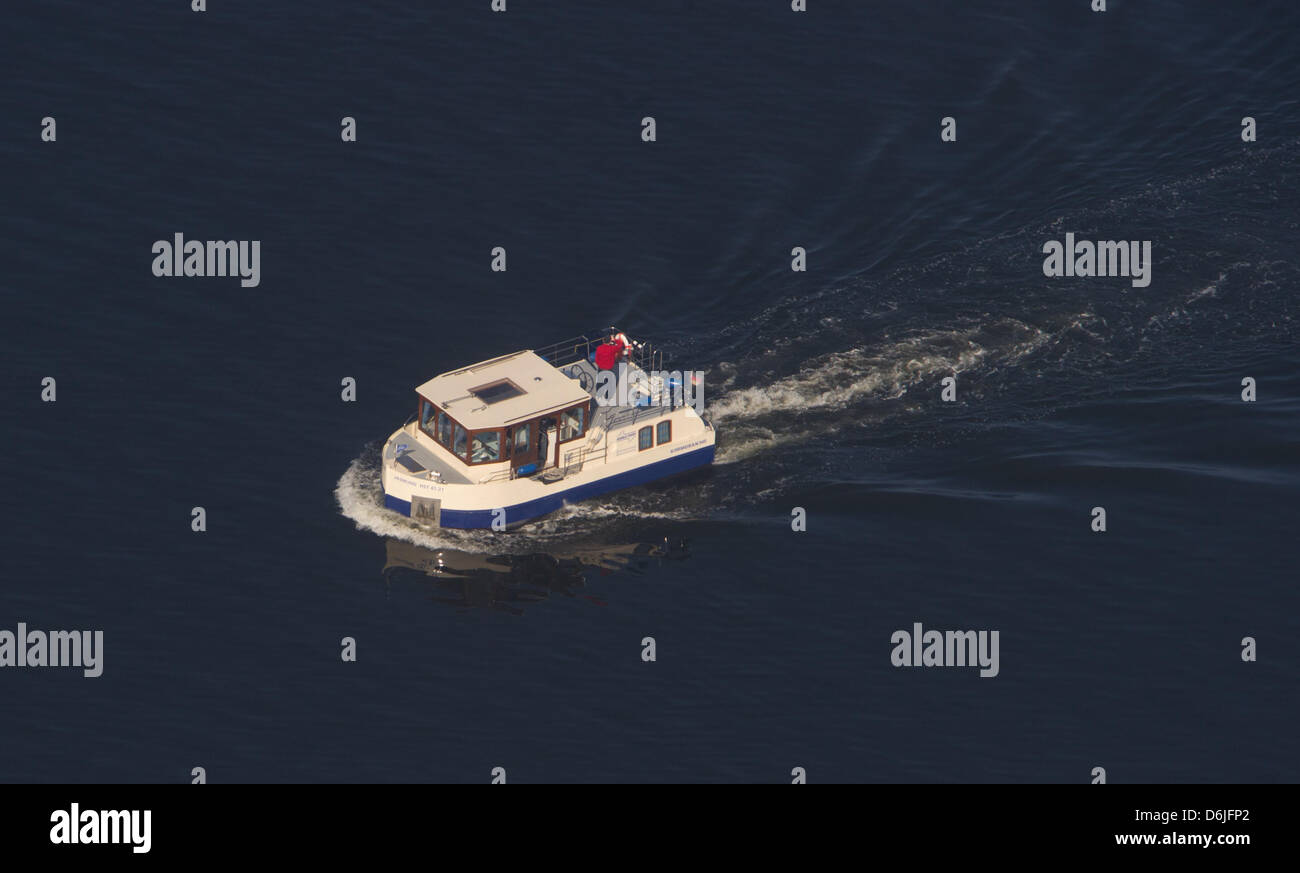 Two men sail with the houseboat 