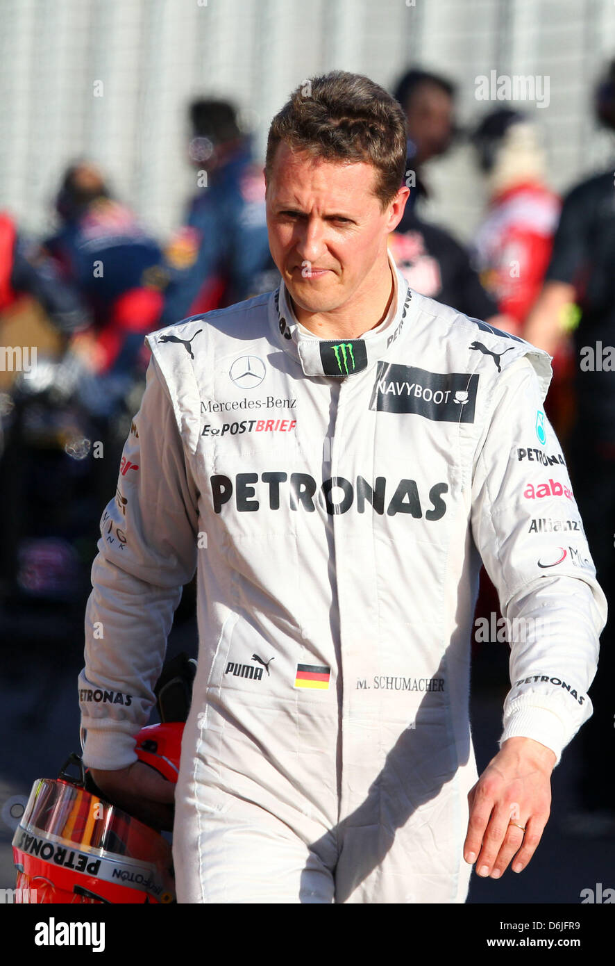 German Formula One driver Michael Schumacher (R) of Mercedes GP walks
