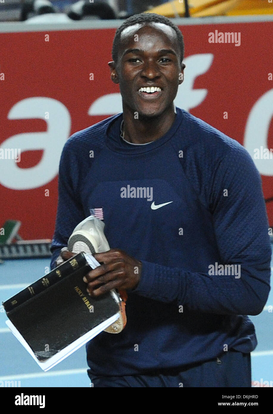 Will Claye of U.S. holds a Bible and his shoes as he celebrates his victory in the Men's triple jump final at the IAAF World Indoor Championships at Atakoy Arena in Istanbul, Turkey, 11 March  2012. Photo: Christian Charisius Stock Photo