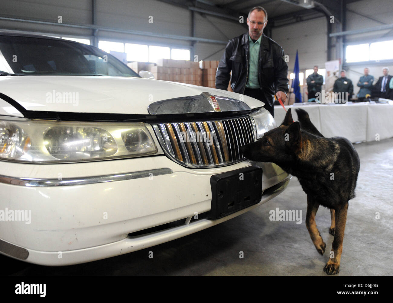 Customs dog handler Horst Dieter Traeger leads the sniffer dog "Arrico