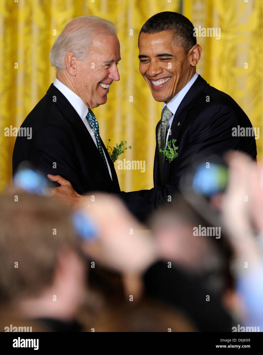 United States President Barack Obama (R) is welcomed by US Vice President Joe Biden as he arrives for a reception for Irish Prime Minister Enda Kenny in the East Room of the White House, March 20, 2012, in Washington, DC. Obama and Kenny concluded a working day devoted to discussions on economic matters, Ireland's peace keeping participations and foreign policy issues like Syria an Stock Photo