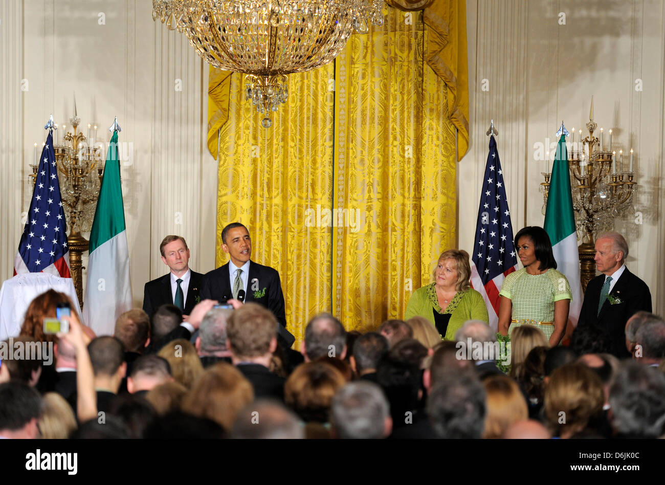 United States President Barack Obama (2nd,L) makes remarks as Irish Prime Minister Enda Kenny (L) listens along with first lady Michelle Obama (2nd,R), Kenny's wife Fionnuala (3rd,R) and Vice President Joe Biden (R) during a reception in the East Room of the White House, March 20, 2012, in Washington, DC. The two leaders concluded a working day devoted to discussions on economic ma Stock Photo