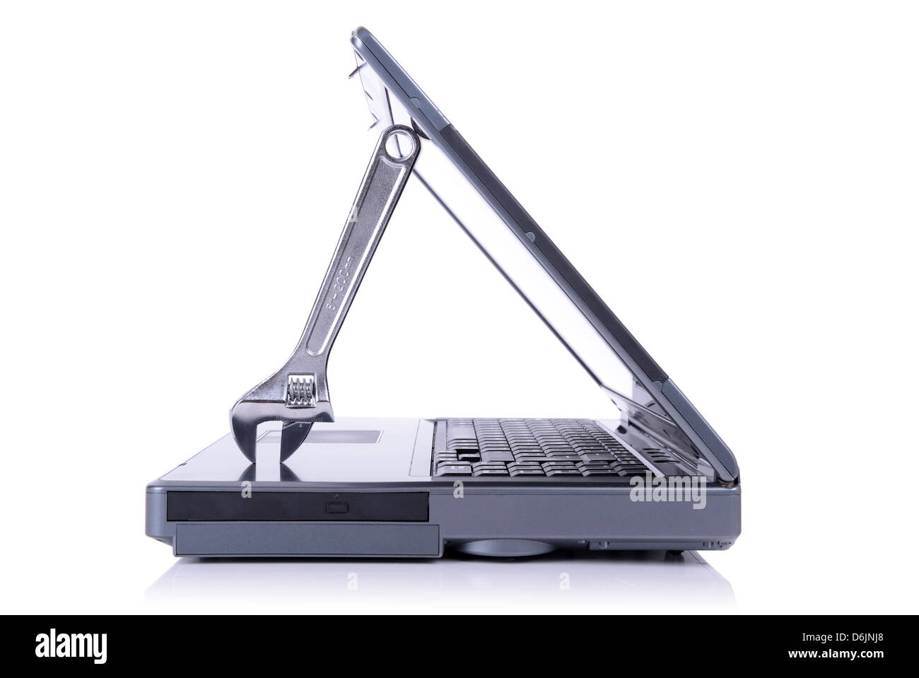 concept of it support with a spanner holding open a laptop isolated on white background Stock Photo