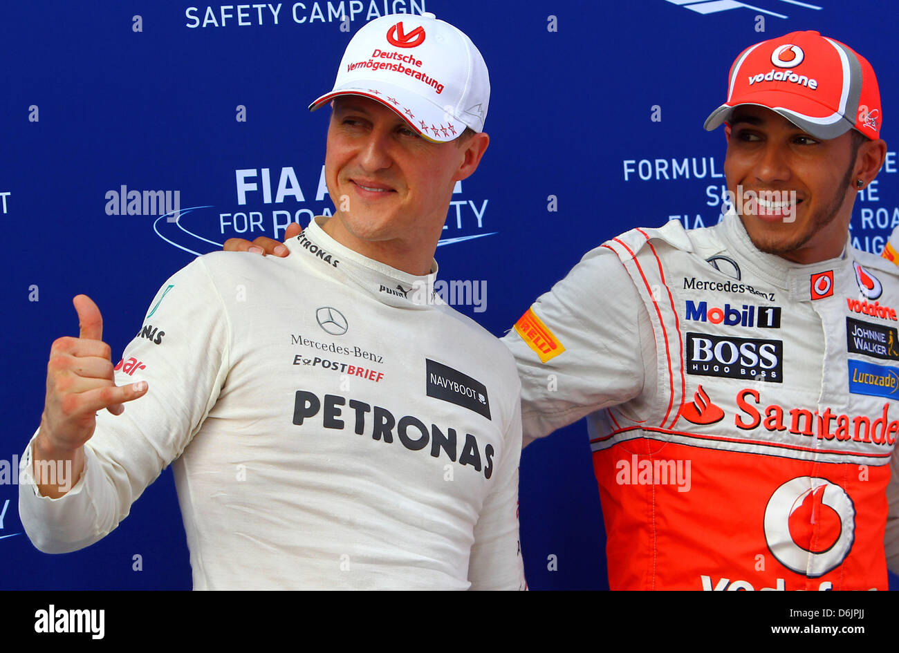 German Formula One driver Michael Schumacher (L) of Mercedes AMG reacts