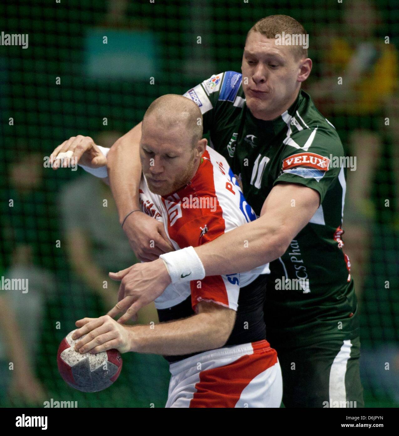 Presov's Dainis Kristopans (R) holds Magdeburg's Ales Pajovic during the Handball EHF Cup men's quarter final second leg match SC Magdeburg versus HT Tatran Presov at Getec Arena in Magdeburg, Germany, 24 March 2012. Photo: JENS WOLF Stock Photo