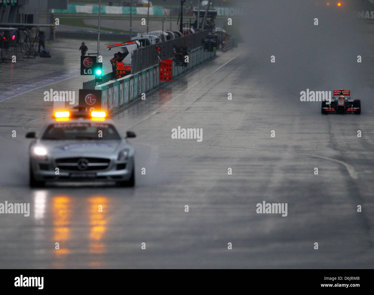 The safety car is back on track in front of the British Formula One driver Lewis Hamilton of McLaren Mercedes during the Formula One Grand Prix of Malaysia at the Sepang circuit, outside Kuala Lumpur, Malaysia, 25 March 2012. Photo: Jens Buettner dpa  +++(c) dpa - Bildfunk+++ Stock Photo