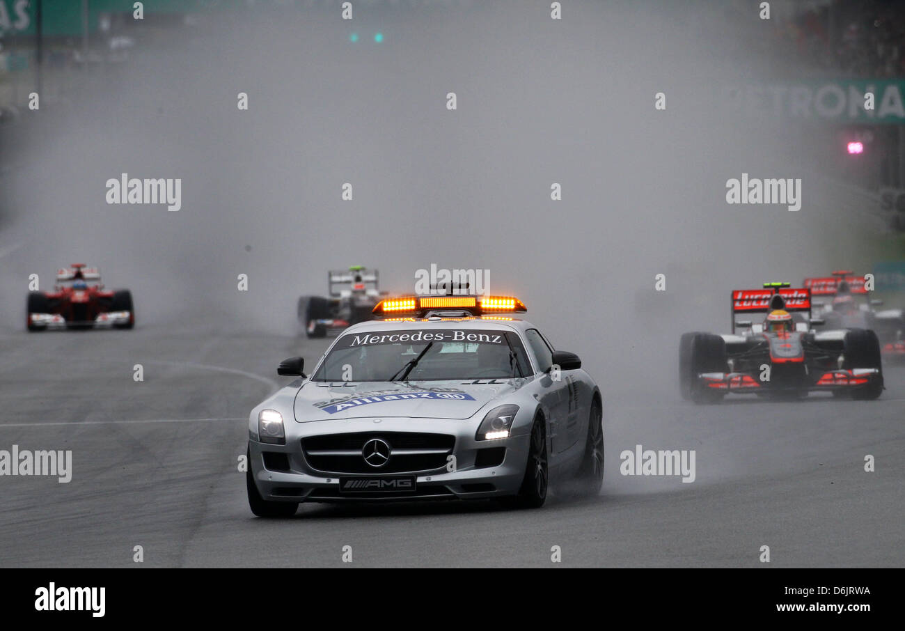 The safety car is back on track in front of the British Formula One driver Lewis Hamilton of McLaren Mercedes during the Formula One Grand Prix of Malaysia at the Sepang circuit, outside Kuala Lumpur, Malaysia, 25 March 2012. Photo: Jens Buettner dpa Stock Photo