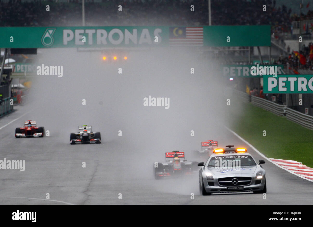The safety car is back on track in front of the British Formula One driver Lewis Hamilton of McLaren Mercedes during the Formula One Grand Prix of Malaysia at the Sepang circuit, outside Kuala Lumpur, Malaysia, 25 March 2012. Photo: Jens Buettner dpa  +++(c) dpa - Bildfunk+++ Stock Photo