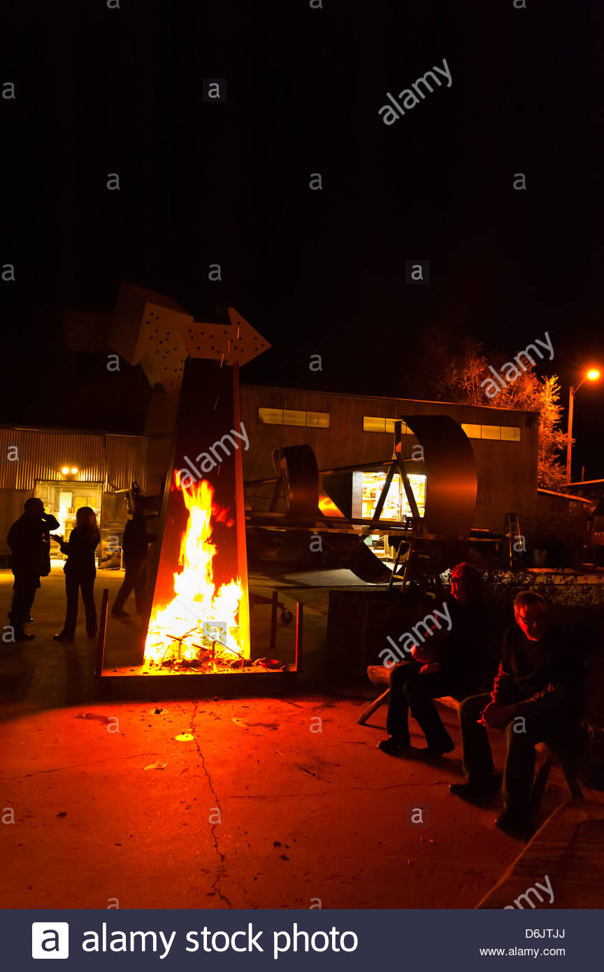 People Sitting Around An Outdoor Fireplace Ironton Studios And