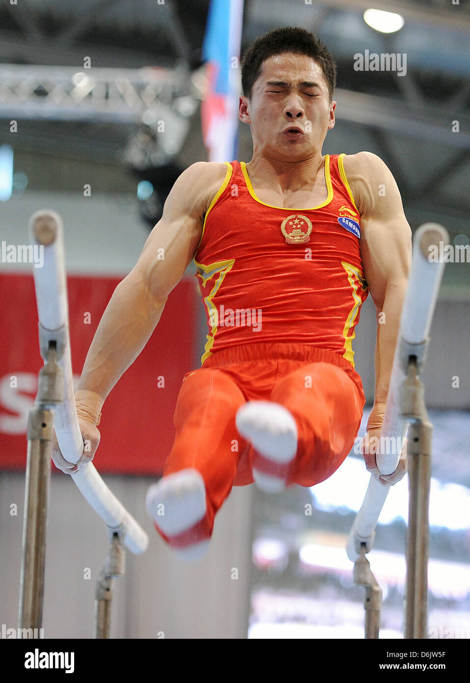 Chinese gymnast Zhou Shixiong performs on the parallel bars during the