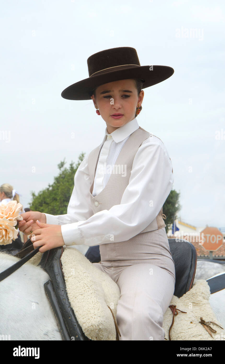 Young girl on horse wearing Cordobes hat in traditional costume during  romeria of Fuengirola, Andalusia, Spain Stock Photo - Alamy