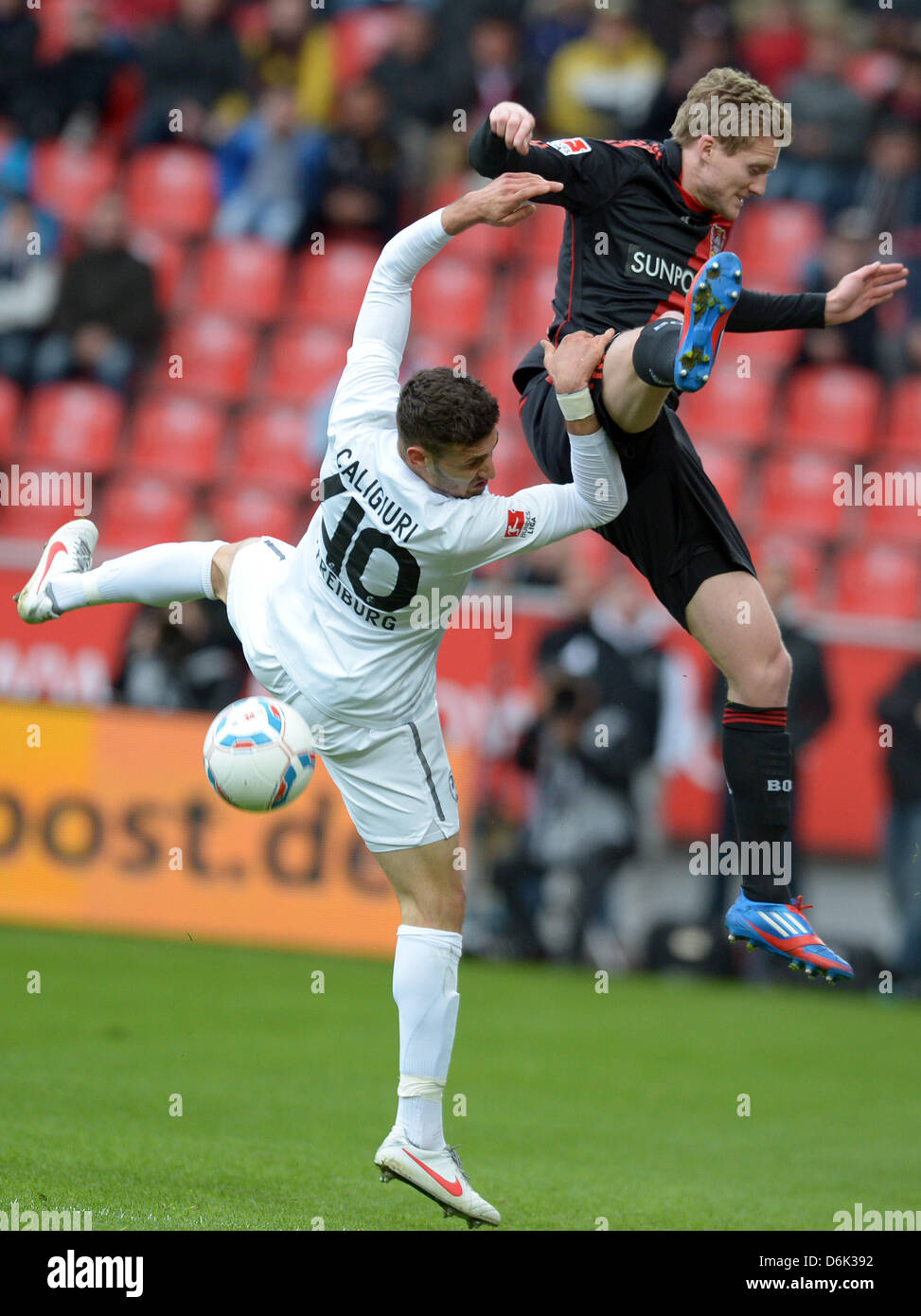 Leverkusen's Andre Schuerrle (R) vies for the ball with Freiburg's Daniel Caligiuri during the German Bundesliga match between Bayer Leverkusen and SC Freiburg at the BayArena in Leverkusen, Germany, 31 March 2012. Photo: FEDERICO GAMBARINI  (ATTENTION: EMBARGO CONDITIONS! The DFL permits the further  utilisation of the pictures in IPTV, mobile services and other new  technologies  Stock Photo