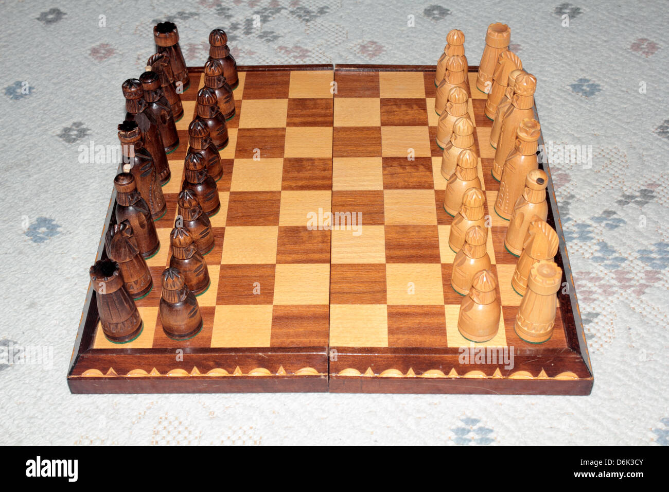 This is a chessboard with all the chess pieces set up in full battle array. Stock Photo