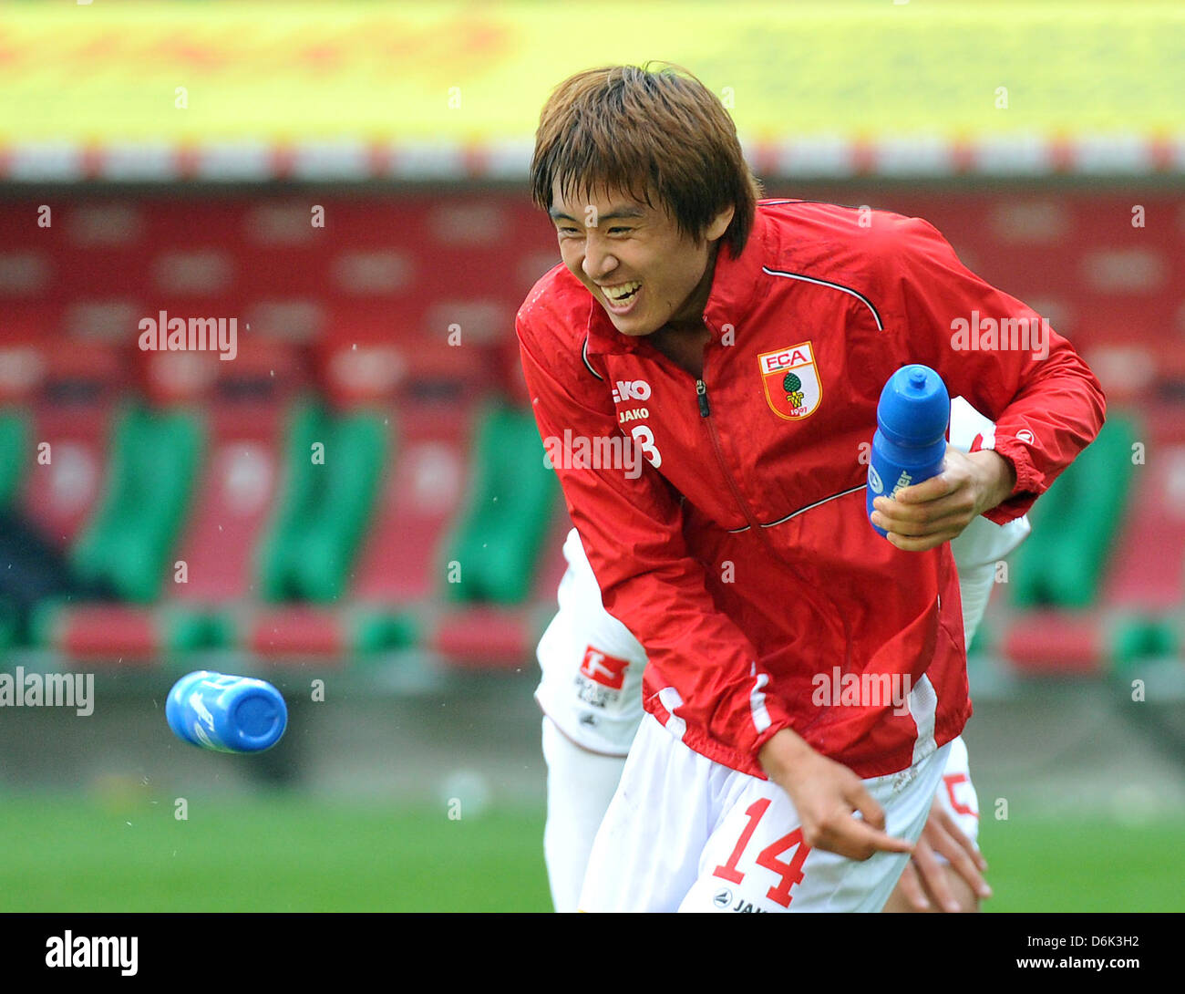 Augsburg's Ja-Cheol Koo cheers after the German Bundesliga match between FC Augsburg and 1. FC Cologne at the SGL-Arena in Augsburg, Germany, 31 March 2012. Augsburg won 2-1. Photo: STEFAN PUCHNER  (ATTENTION: EMBARGO CONDITIONS! The DFL permits the further  utilisation of the pictures in IPTV, mobile services and other new  technologies only no earlier than two hours after the end Stock Photo