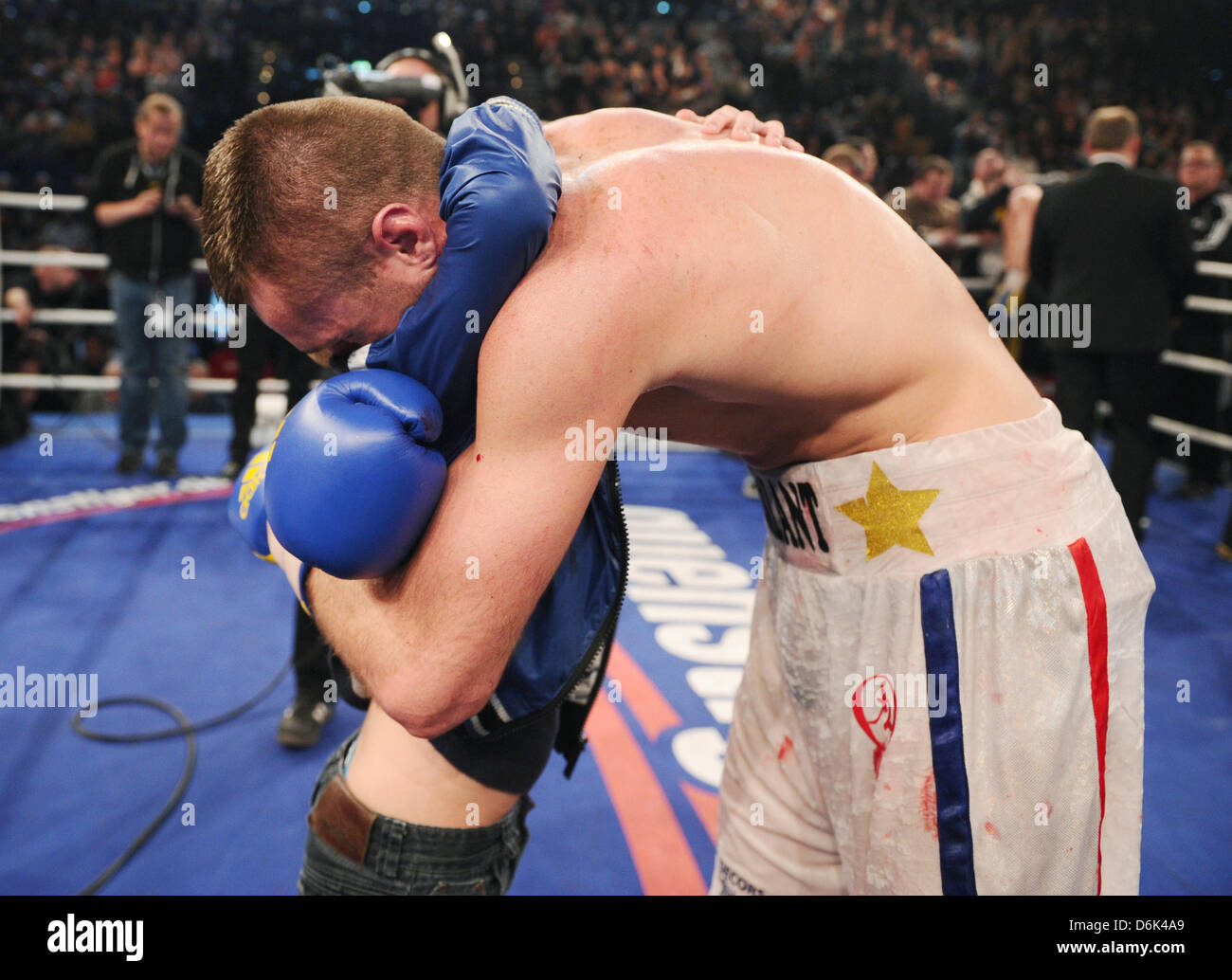 French light heavyweight boxer Tony Averlant hugs his son after the fight  for the light heavyweight European Chanpionship against German boxer  Gutknecht at the Sparkassen Arena in Kiel, Germany, 31 March 2012.