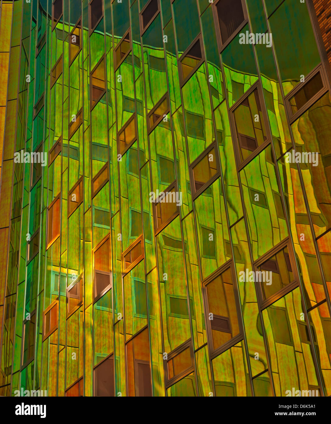 Office building with green, yellow and orange reflexions in windows Stock Photo
