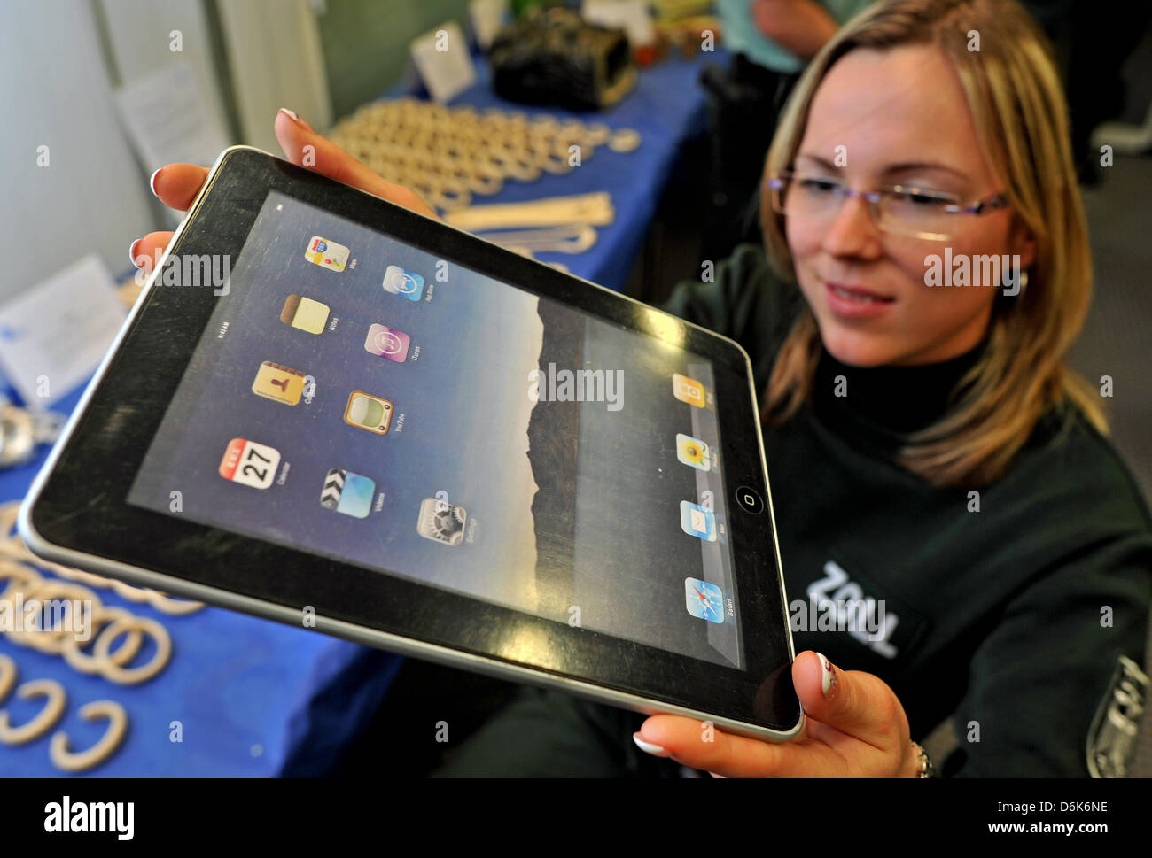 Customs secretary Christiane Jeschke-Bahn holds a rip-off of tablet computer at the Leipzig/Halle airport in Leipzig, Germany, 04 April 2012. Customs officers in Saxony have confiscated markedly more counterfeit products and drog last year, according to the main customs office in Dresden at a press conference in Leipzig. Customs confiscated around 2500 packages of counterfeits word Stock Photo