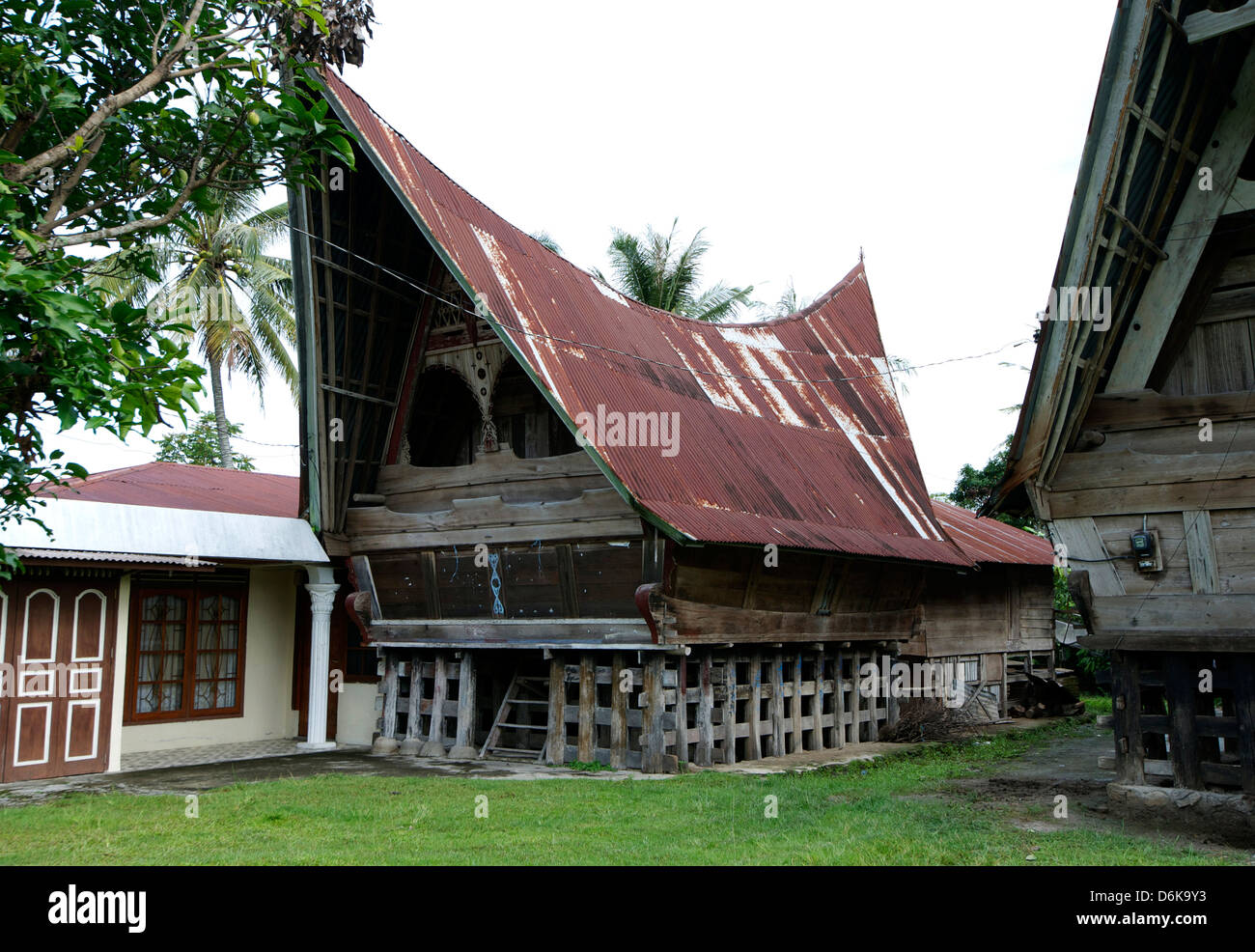 Batak Toba tribal rural village houses with contemporary extensions on Samosir Island in Lake Toba, Sumatra, Indonesia Stock Photo