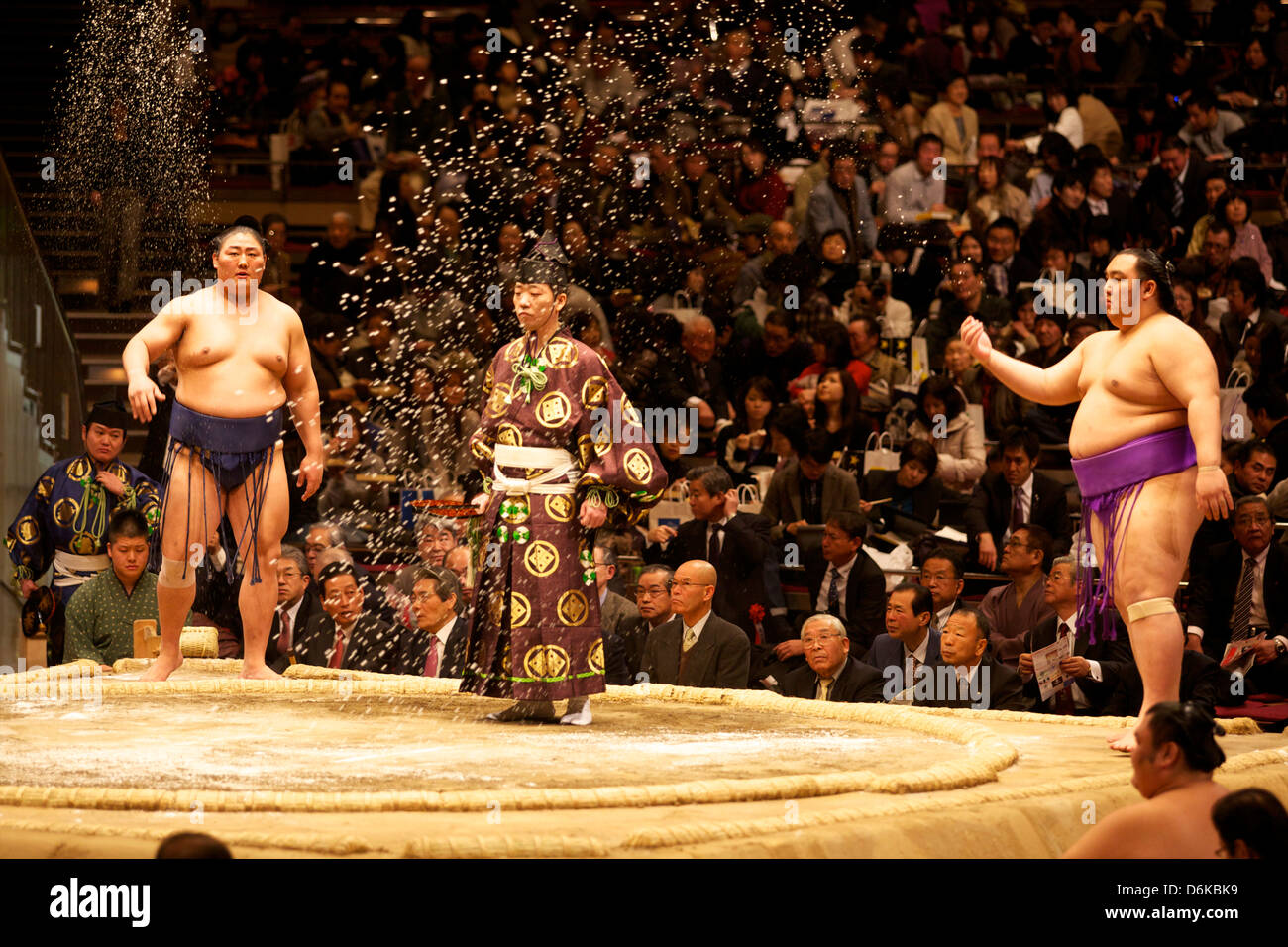 Some sumo fighters throwing salt before a fight at the Kokugikan stadium, Tokyo, Japan, Asia Stock Photo