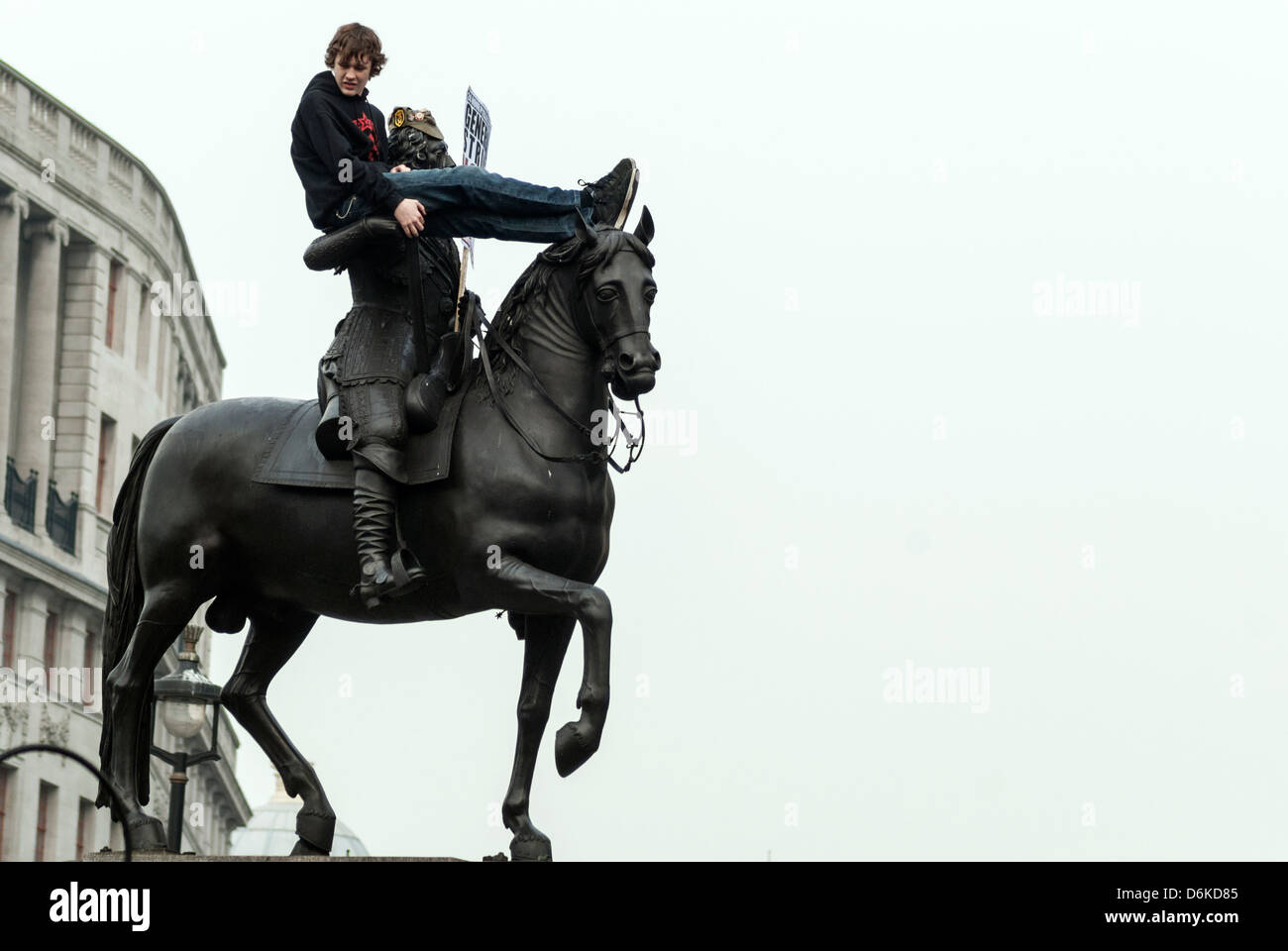 A protester is sitting on the statue of Charles I in Trafalgar Square. Stock Photo